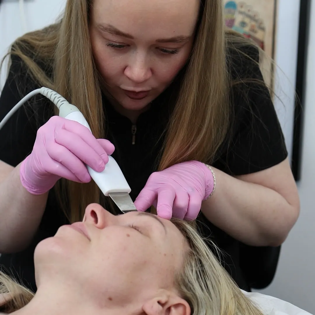 Gemma treating a client reclined in the treatment chair