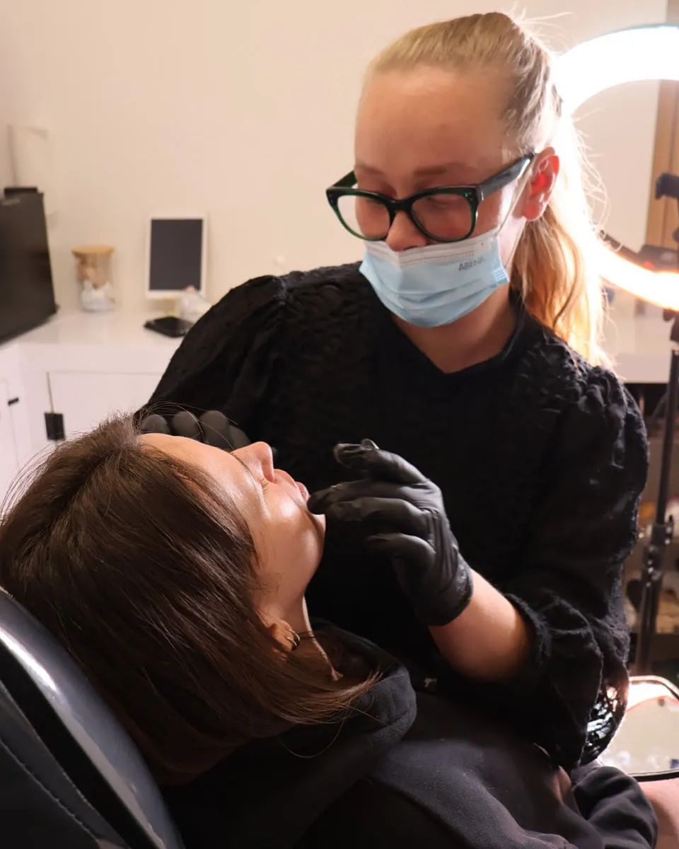 Gemma talking a client through a treatment at the chair